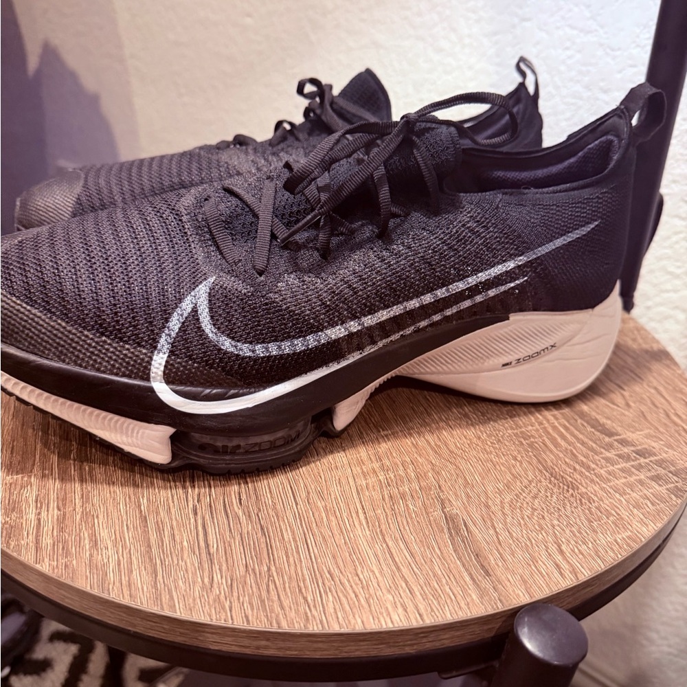 Nike Air Zoom Tempo NEXT% Flyknit shoes in a black and white colorway
